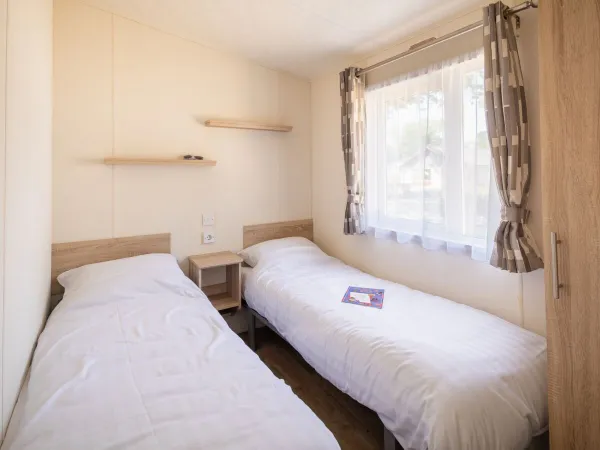 First bedroom with two single beds within the Comfort Lounge.