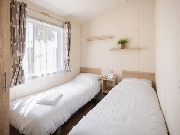 Second bedroom with two single beds within the Comfort Lounge.