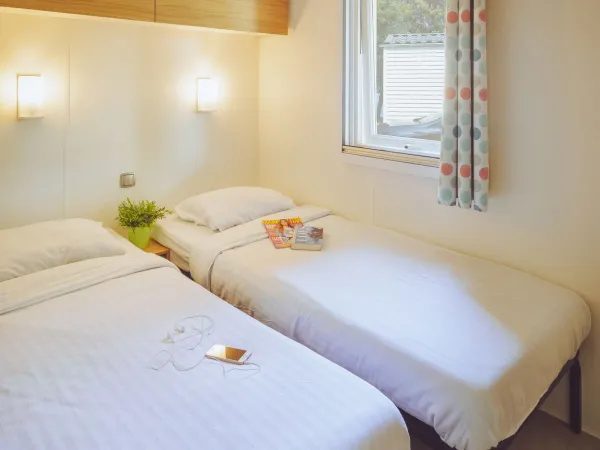 The Roan Premium Lounge bedroom with two single beds.