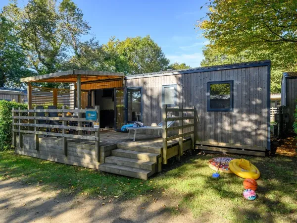 The Roan Premium decking features a dining table with garden chairs.