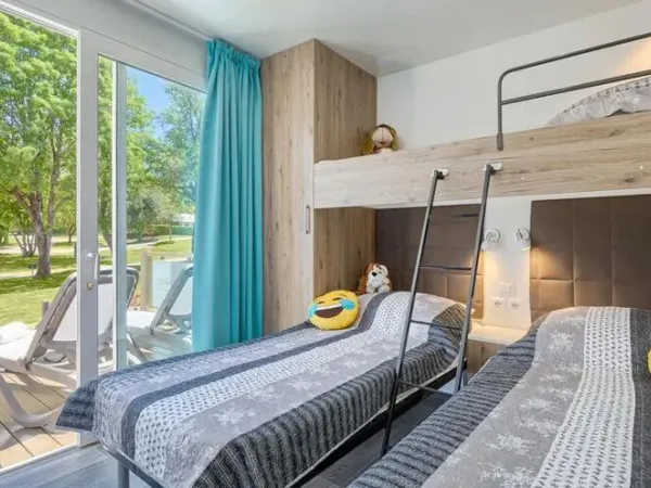 The Roan Premium Lounge bedroom with three single beds.