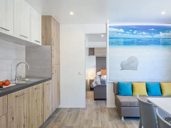 The Roan Premium Lounge living room features a spacious kitchen and dining table.