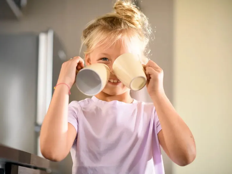 Girl laughing in the kitchen.