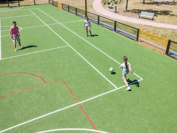 Playing soccer on the sports field at Roan camping De Schatberg.