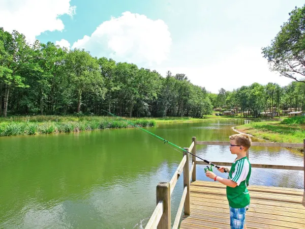 Fishing in the lake at Roan camping Avit Loisirs.