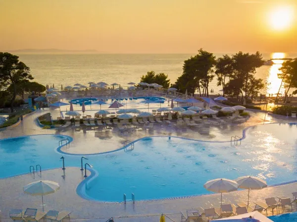 Evening sun over the sea and pool at Roan campsite Zaton Holiday resort.