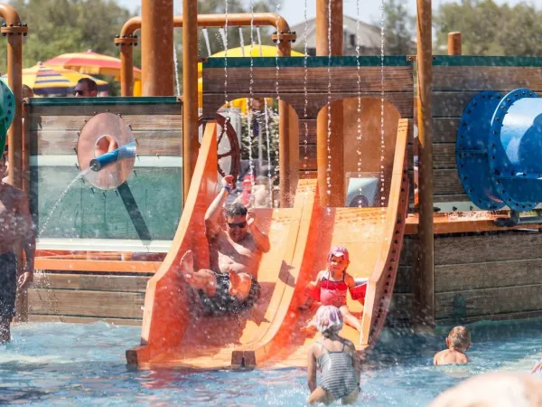 Toys and slides in the pool at Roan camping Pra'delle Torri.