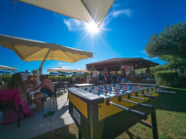 Table soccer and a terrace at Roan camping Rubicone.