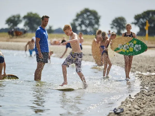 Surfboarding in the pond at Roan camping Terspegelt.