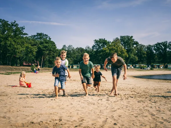 The sandy beach by the natural pool at Roan camping The Schatberg.