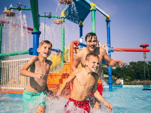 Swim in the outdoor pool with water playground at Roan camping De Schatberg.