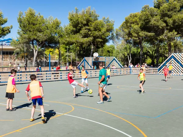 Playing soccer at Roan camping Vilanova Park.