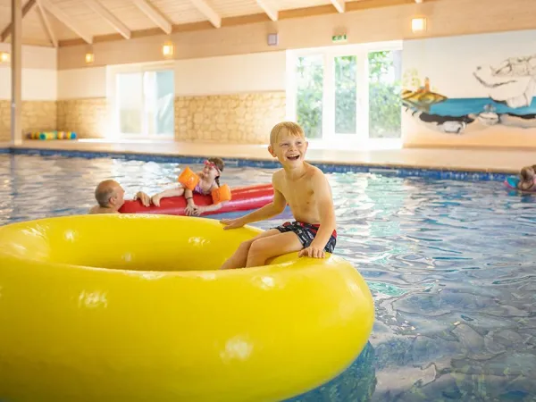 Child plays in swimming band at Roan campsite Marvilla Parks Friese Meren.