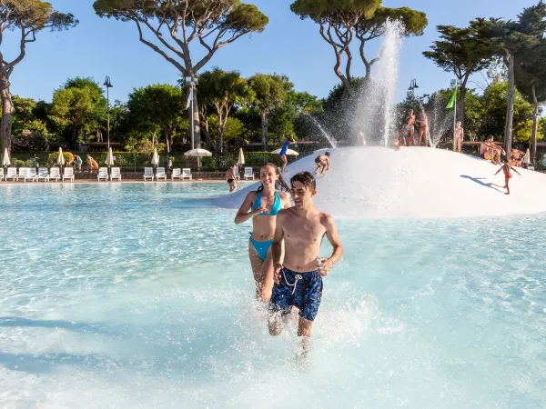 Children run through the lagoon pool at Roan camping hu Park Albatros village.