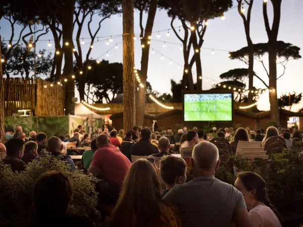 Watching soccer on the terrace at Roan camping Park Albatros.