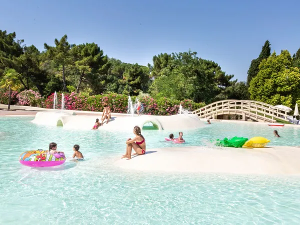 Children's pool with soft surface and sliding hills at Roan camping Norcenni Girasole.