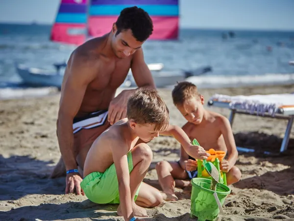 Enjoying children at the beach at Roan camping Mediterraneo.