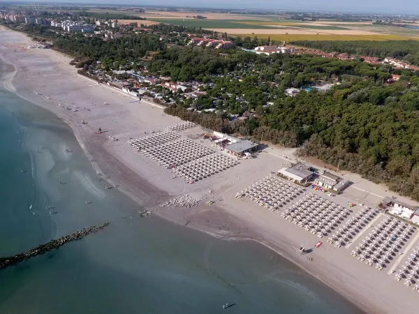 Drone shot of the beach at Roan camping Adriano Village.
