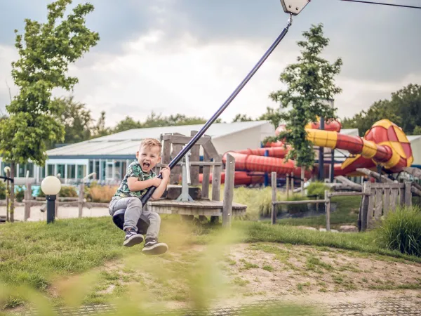 Fun in the playground, sliding down the cable car at Roan camping Ackersate.