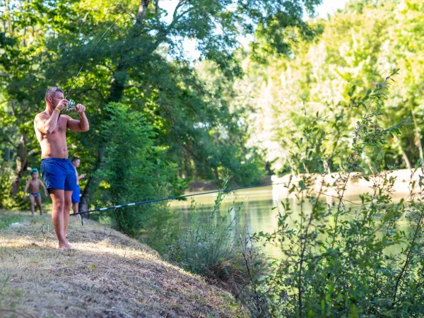 Fishing in the pond at Roan camping Château de Fonrives.