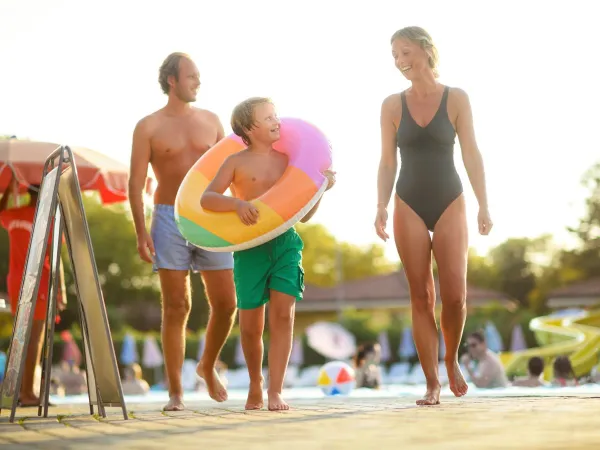 Father, mother and child by the pool at Roan camping.