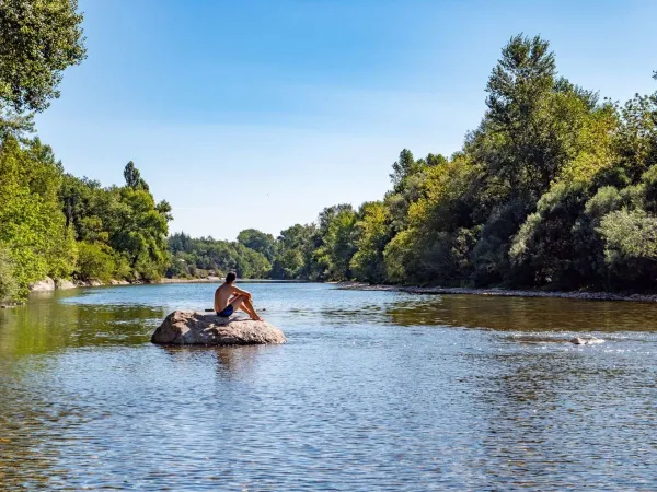 Relax on rock in the river near Roan camping Le Ranc Davaine.