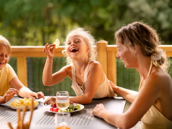 Family drinks by lounge set in Roan camping Belvedere.