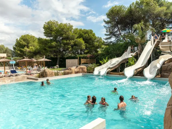 Swimming pool with slides at Roan camping El Garrofer.