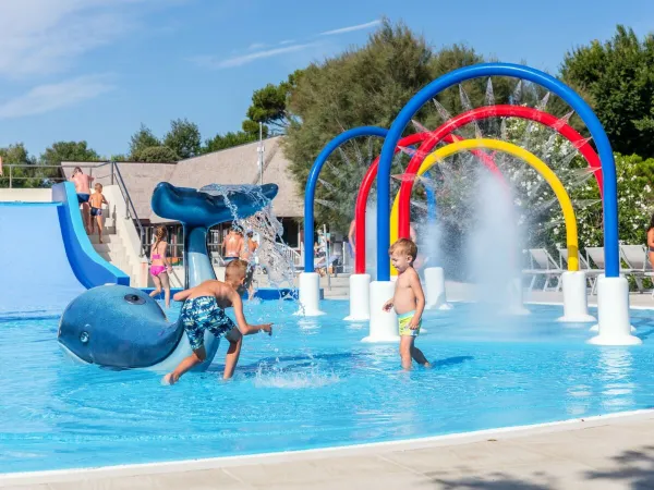 Children playing in children's pool at Roan camping San Francesco.