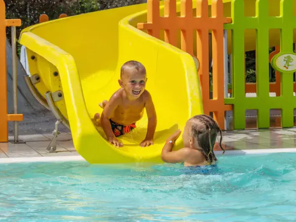 Child slides down fun slide at Roan camping Rubicone.