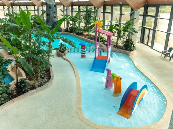 Water playground in indoor pool at Roan camping Domaine des Ormes.