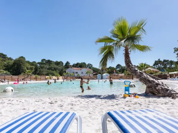 Children playing in the lagoon pool at Roan camping La Clairière