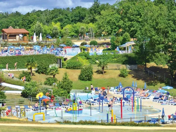 Overview of the water park and pools in the distance at Roan camping Saint Avit Loisirs
