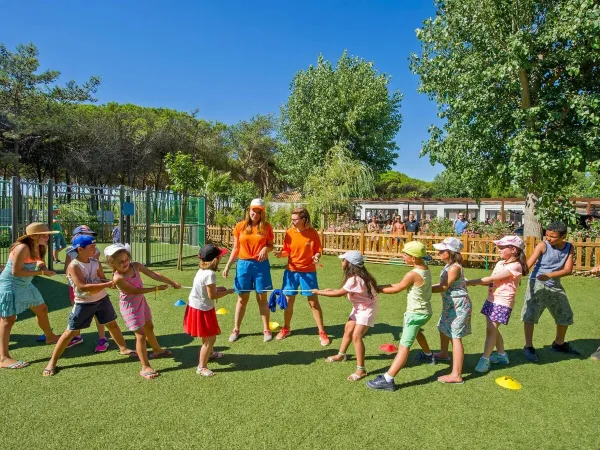 Children play the game of tug-of-war at Roan camping Le Castellas.