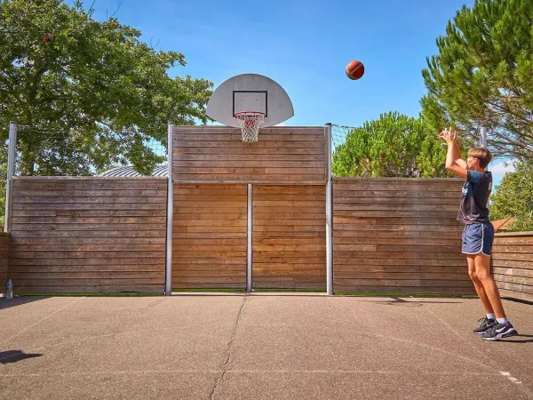 Boy playing basketball at Roan camping Mayotte Vacances.