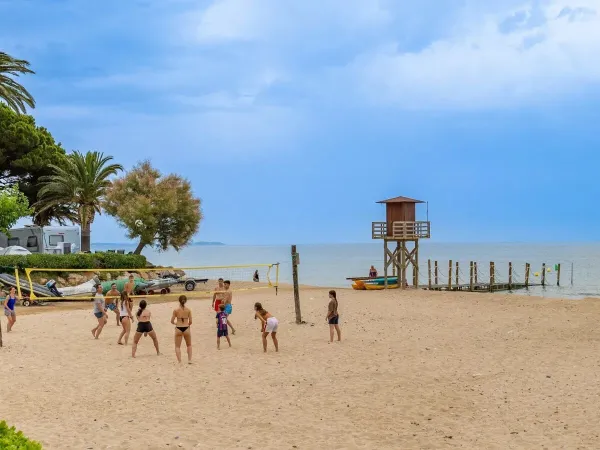 Playing beach volleyball at Roan campsite Playa Montroig.