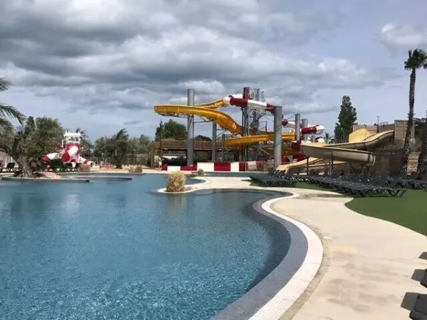 The beautiful swimming pool with new water playground and slides at Roan camping Les Dunes.