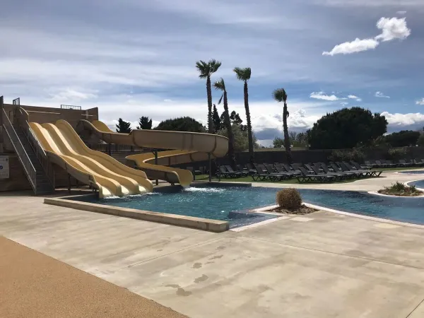 Fun slides and sunbathing area at Roan camping Les Dunes.