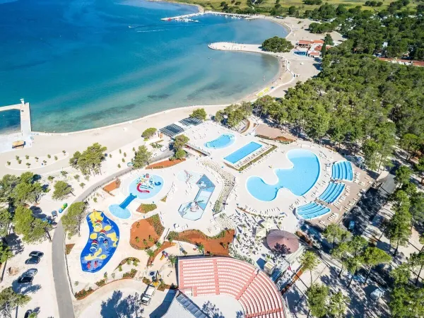 Overview of the swimming pool and beautiful bay at Roan campsite Zaton Holiday resort.