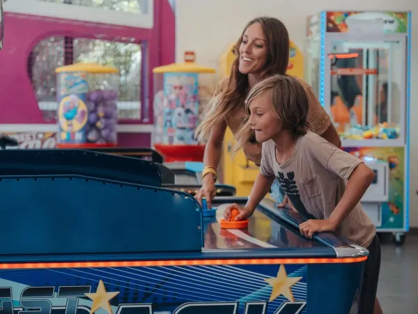 Mother and son at the slot machines at Roan campsite Les Méditerranées Beach Garden.