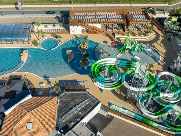 Overview of the new children's playground and several slides at Roan camping Le Domaine du Clarys.