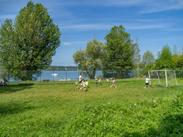 Children play football on the football pitch at Roan campsite Okay Lido.