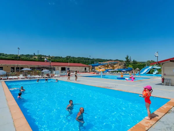 Families take a dip in the pool at Roan camping Chateau de Galaure.