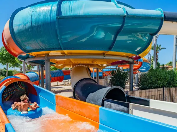 Down the fast slide with a tyre at Roan camping Le Soleil de la Méditerranée.