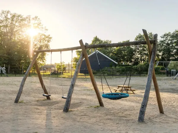 The sand playground with swings at Roan camping de Twee Bruggen.