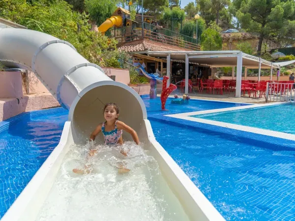 Girl on the pool slide at Roan campsite Cala Canyelles.