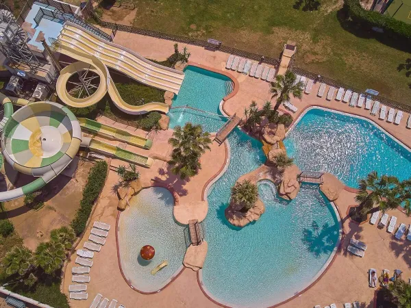 Aerial view of the beautiful swimming pool with slides at Roan campsite Le Petit Mousse.