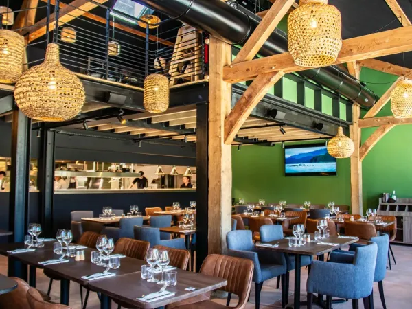 Atmospheric restaurant with open kitchen at Roan campsite Domaine des Ormes.