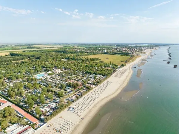 Aerial view of the campsite, coastline, beach and sea.