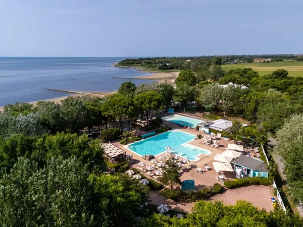 Overview of pool and beach at Roan campsite Tenuta Primero.